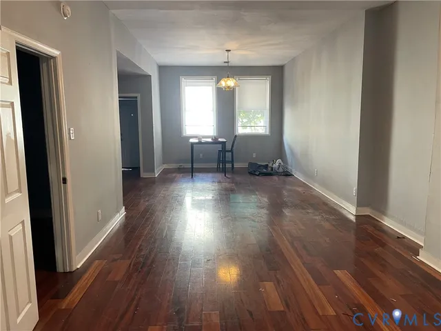a view of a room with wooden floor and furniture