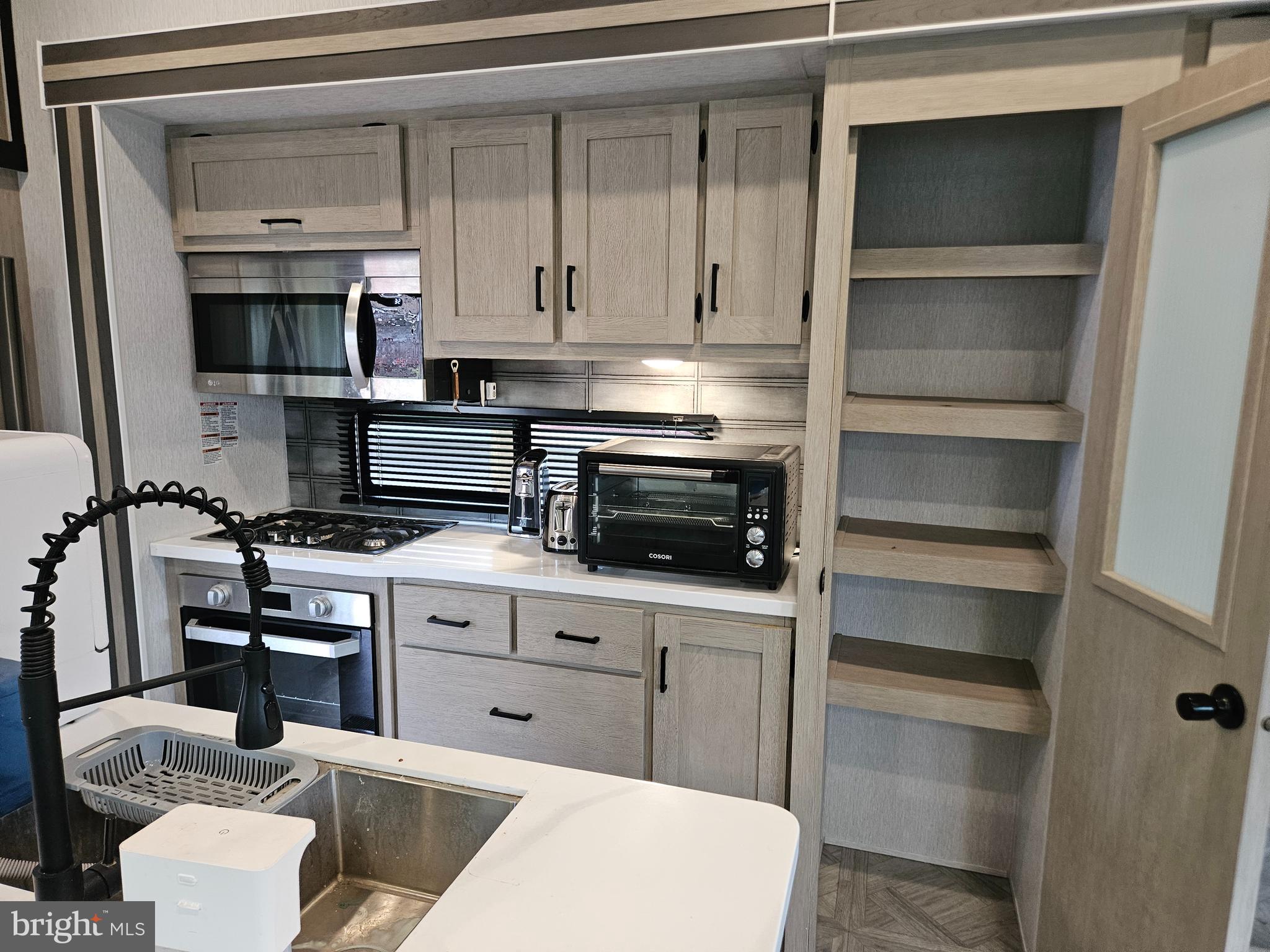 11 Ranger Road Falling Waters, WV 25419 - Photo 19 of 48 a kitchen with kitchen island a sink stainless steel appliances and cabinets