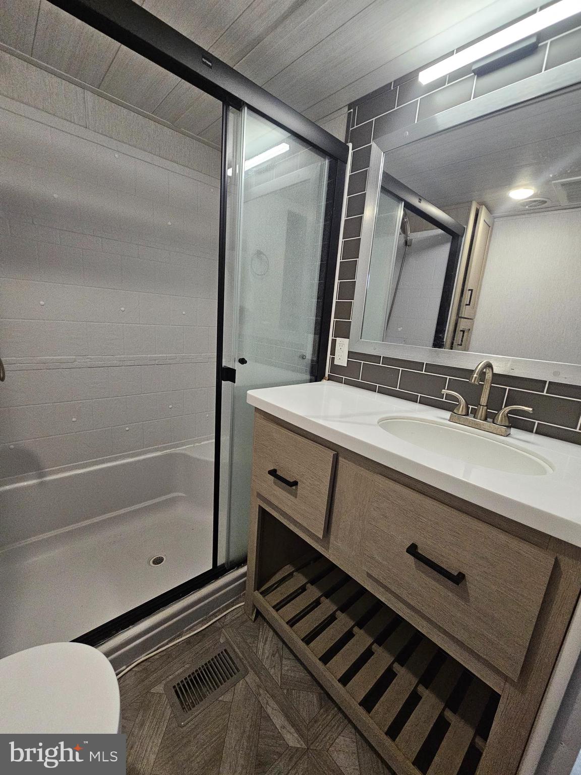 11 Ranger Road Falling Waters, WV 25419 - Photo 23 of 48 a bathroom with a granite countertop sink a mirror and shower