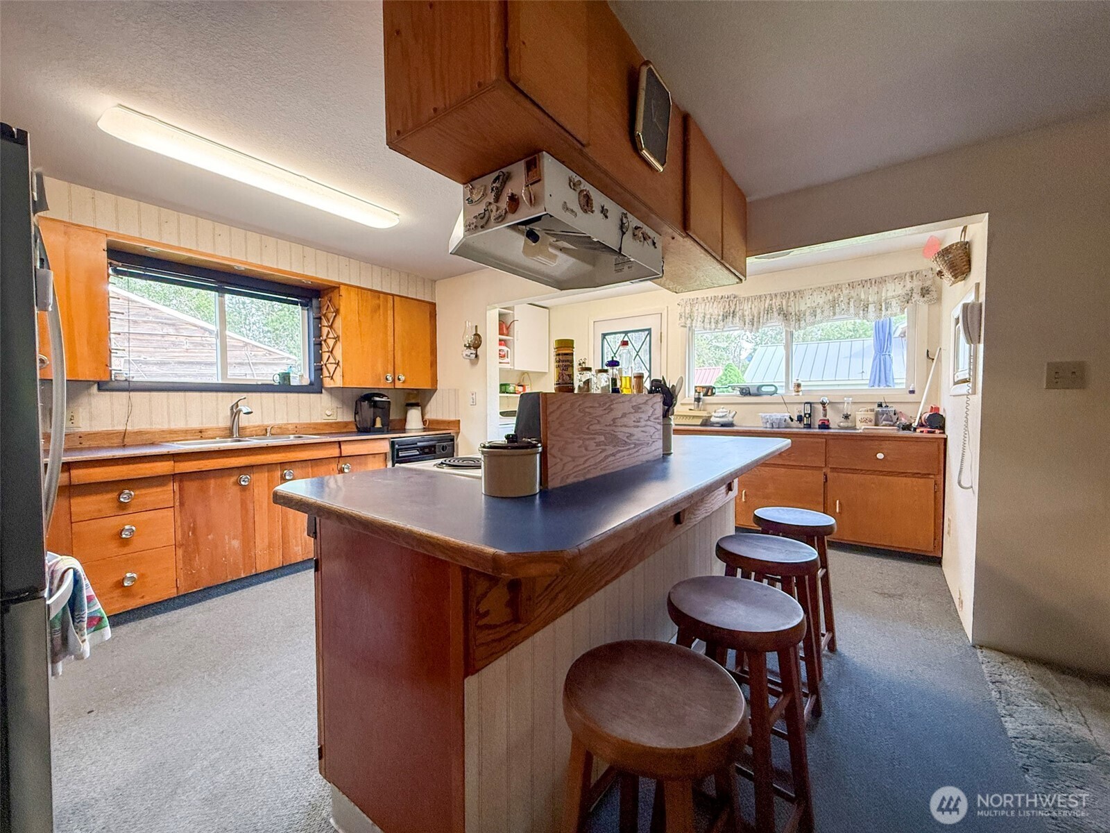 518 Bridge Street Twisp, WA 98856 - Photo 14 of 40 a kitchen with stainless steel appliances a table and chairs in it