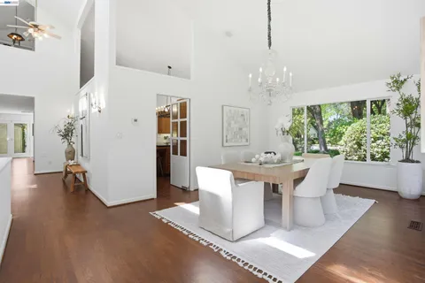 a living room with furniture a window and a potted plant