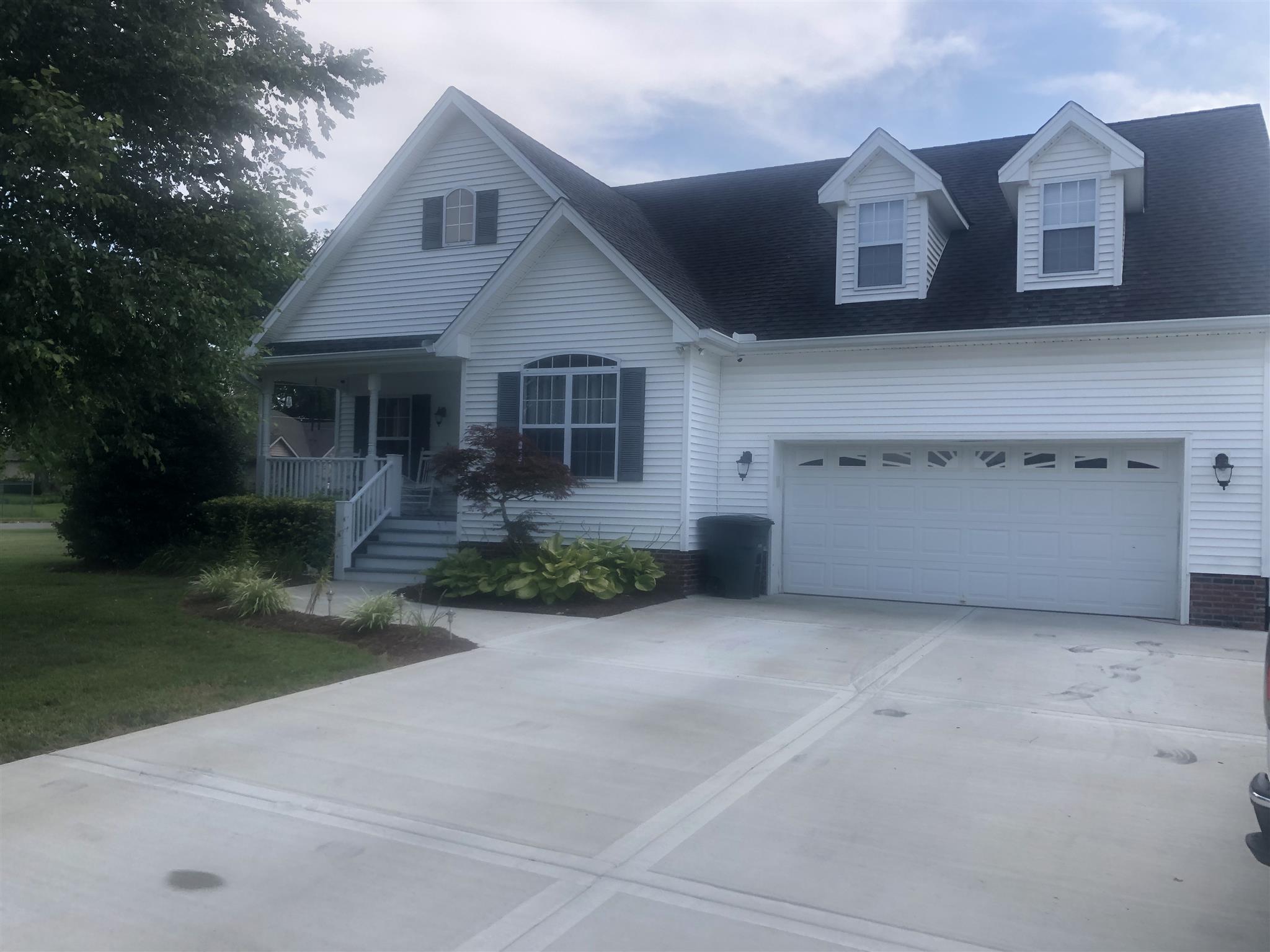 478 Jim Courtney Road Portland, TN 37148 - Photo 1 of 17 a front view of a house with a yard and garage