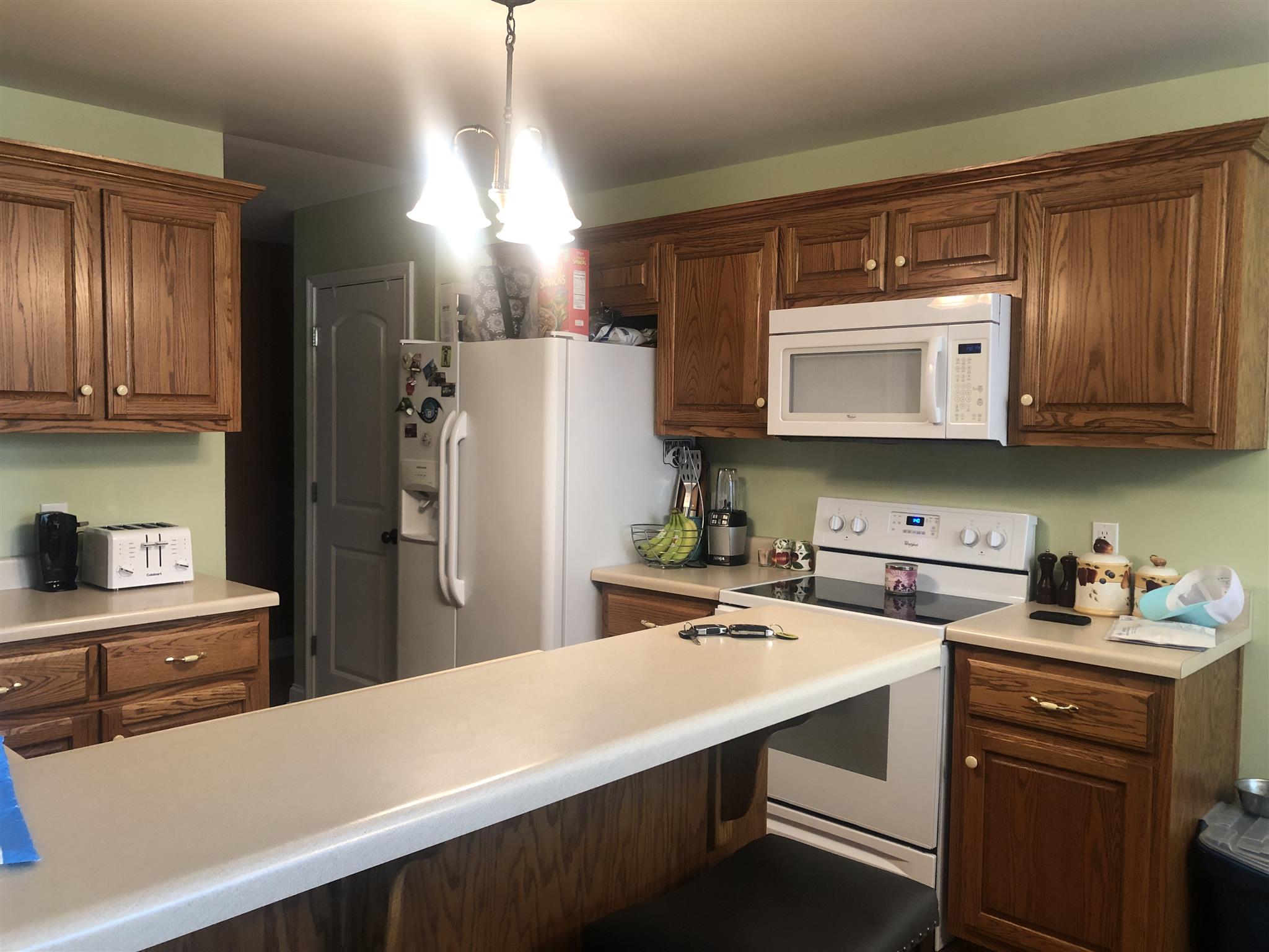 478 Jim Courtney Road Portland, TN 37148 - Photo 8 of 17 a kitchen with a sink a refrigerator and cabinets