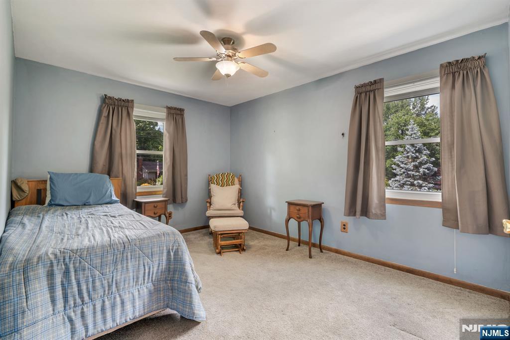 55 Marcia Road Ringwood, NJ 07456 - Photo 19 of 42 a bedroom with a bed and a chandelier