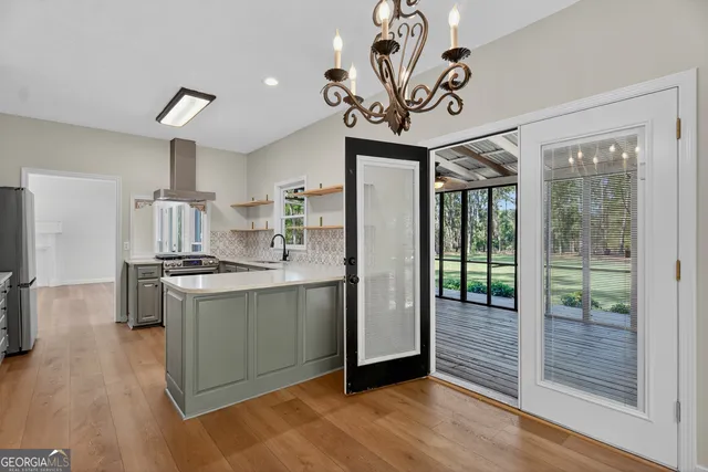 a kitchen with kitchen island granite countertop a stove a sink and a refrigerator