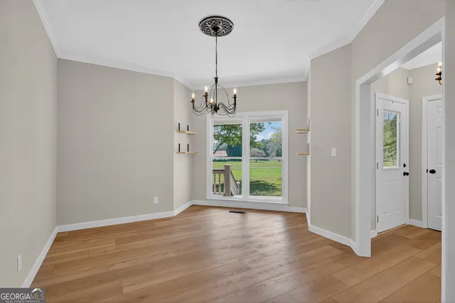 a view of a room with window wooden floor and chandelier