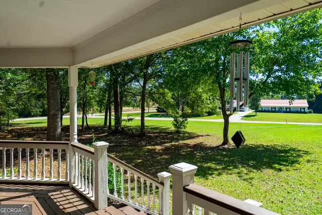 a view of a garden with trees in the background