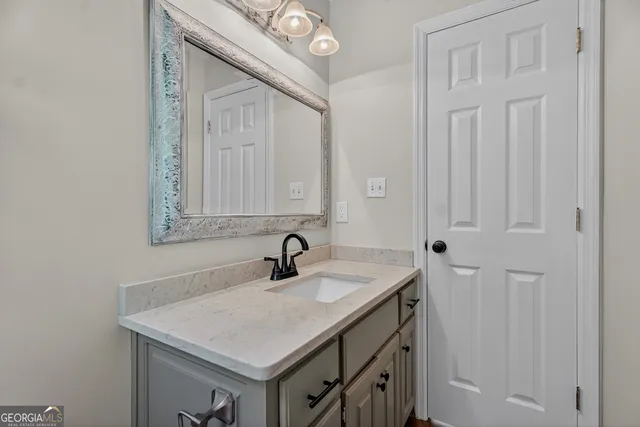 a bathroom with a sink and a mirror
