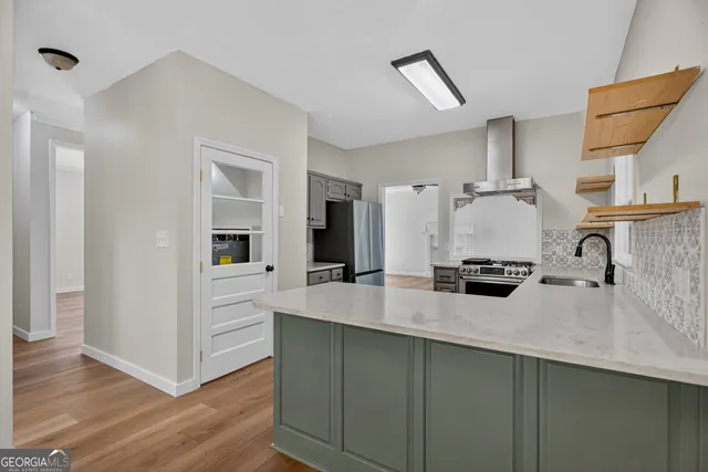 a kitchen with kitchen island a sink appliances and cabinets