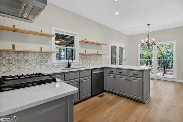 a kitchen with a sink stove and cabinets