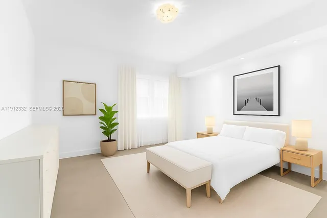 a bedroom with a large bed and a potted plant