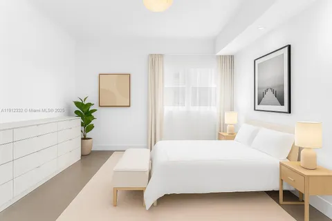 a room with a bed and a potted plant