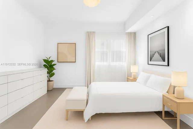 a room with a bed and a potted plant