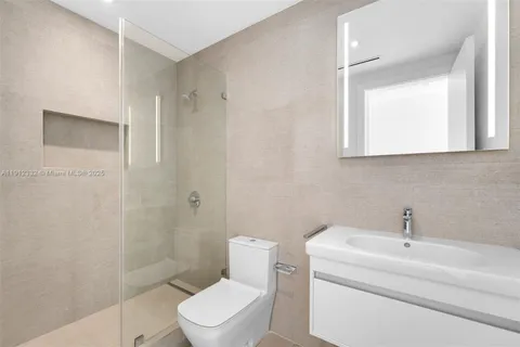 a bathroom with a toilet sink and shower