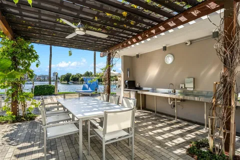a view of a kitchen with a table and chairs in a patio
