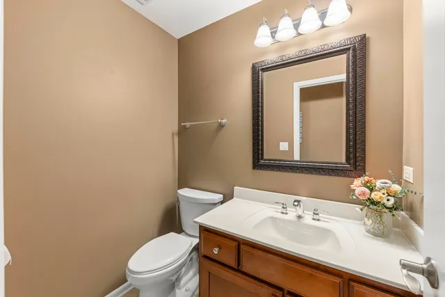 a bathroom with a sink a toilet and mirror
