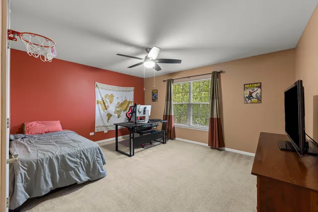 a spacious bedroom with a bed and a chandelier