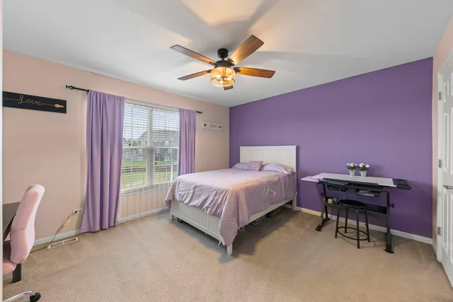 a bathroom with a double vanity sink a mirror and a bathtub