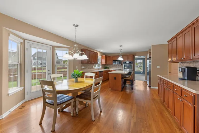 a dining room with furniture window and wooden floor