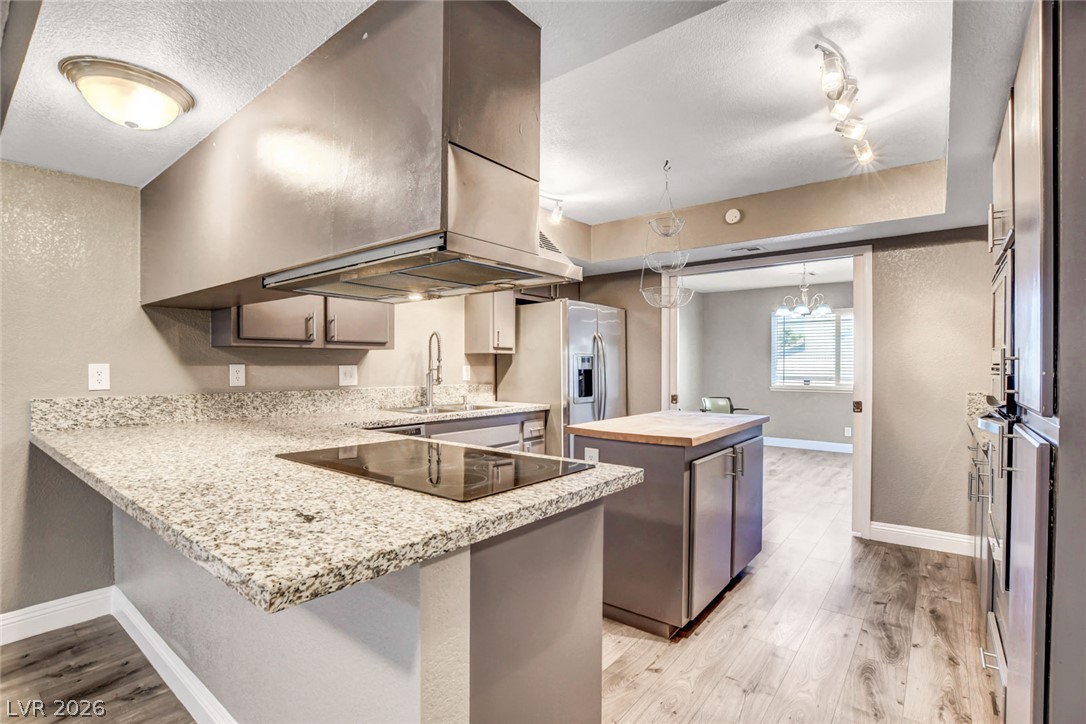 4367 South Mojave Road Las Vegas, NV 89121 - Photo 20 of 53 A contemporary kitchen features granite counters, stainless steel appliances, and sleek wooden floors.