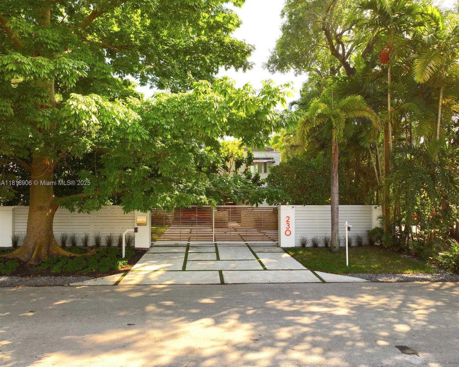 230 Ridgewood Road Coral Gables, FL 33133 - Photo 1 of 19 a white house with trees in front of it
