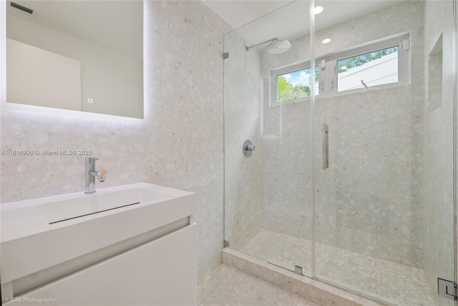 230 Ridgewood Road Coral Gables, FL 33133 - Photo 11 of 19 a bathroom with a shower a sink and a mirror