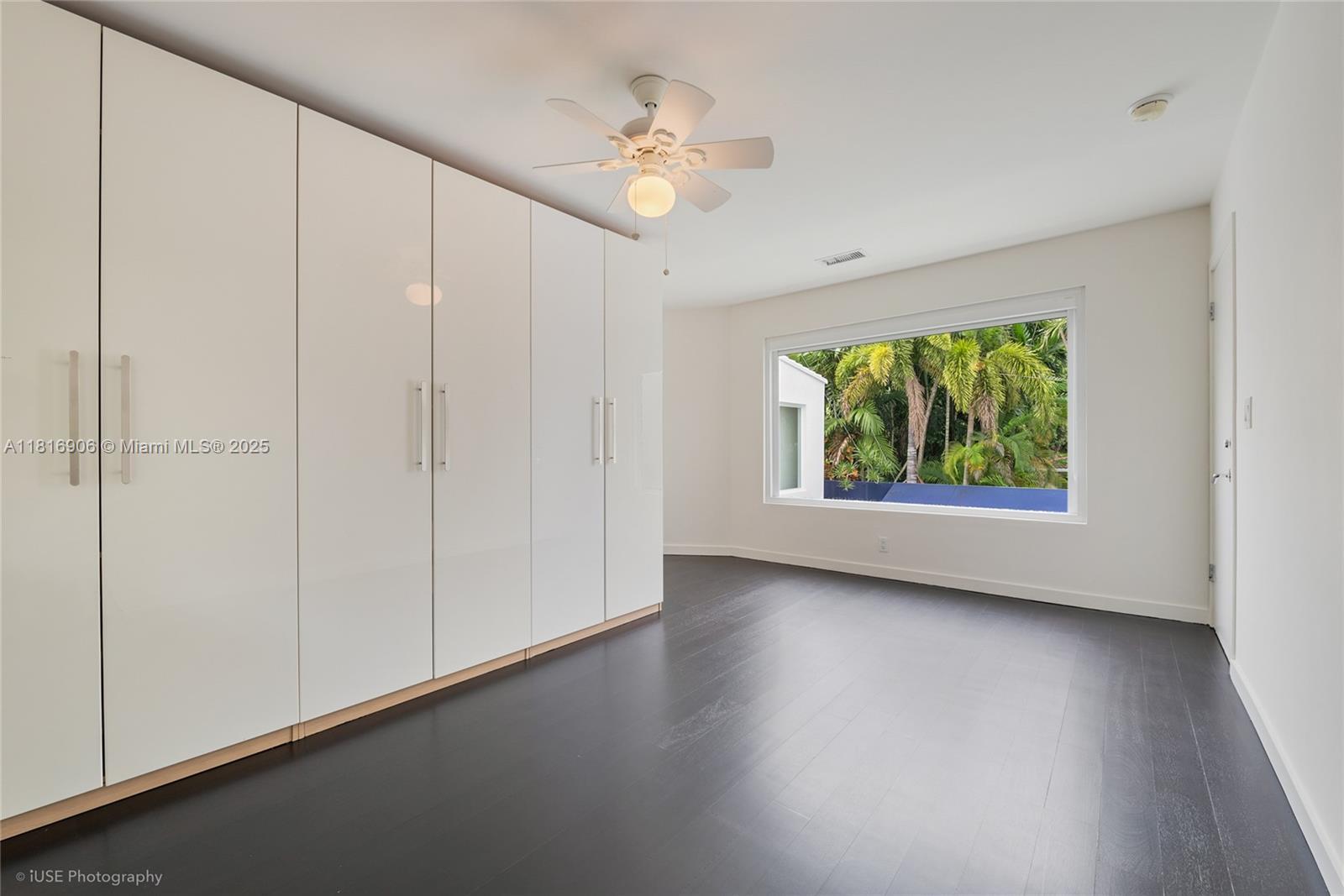 230 Ridgewood Road Coral Gables, FL 33133 - Photo 14 of 19 an empty room with windows and ceiling fan