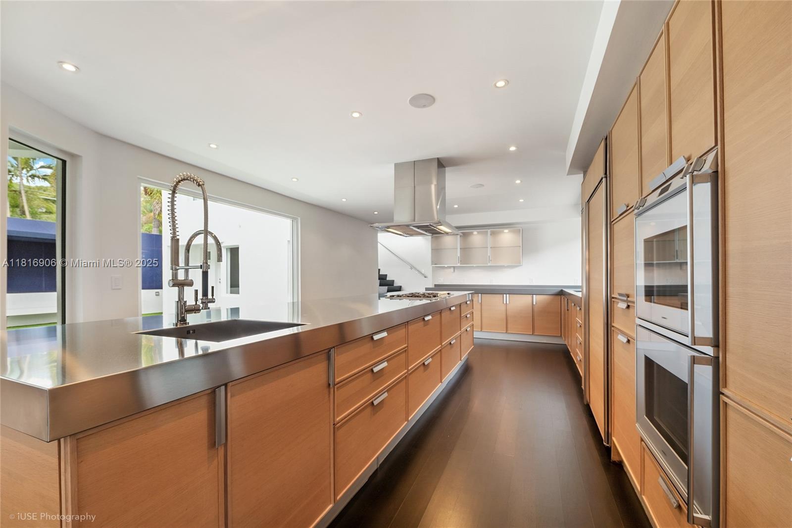 230 Ridgewood Road Coral Gables, FL 33133 - Photo 16 of 19 a kitchen with stainless steel appliances sink a stove and cabinets