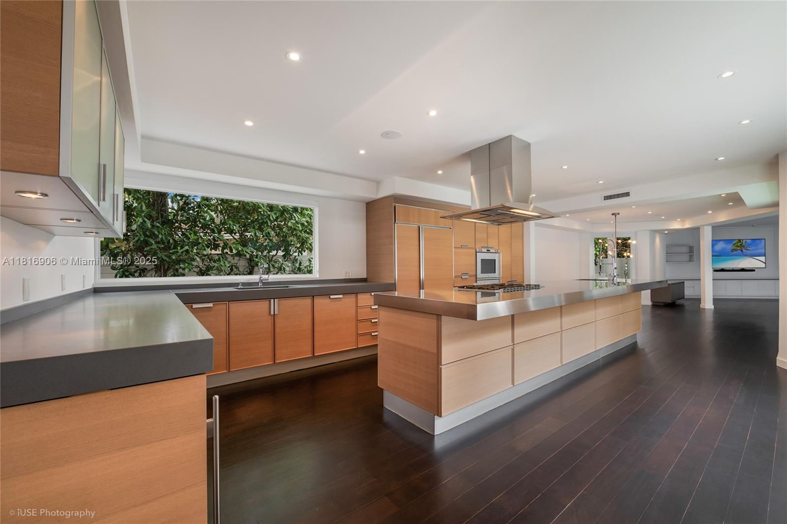 230 Ridgewood Road Coral Gables, FL 33133 - Photo 3 of 19 a kitchen with stainless steel appliances granite countertop a sink and a large window
