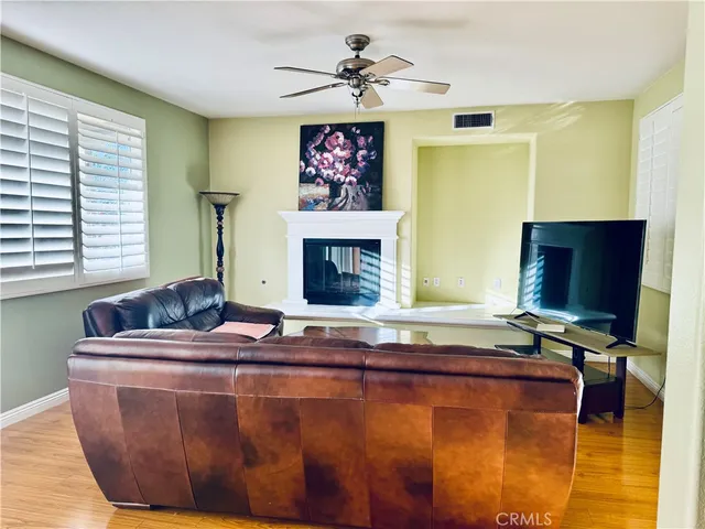 a living room with fireplace furniture and a flat screen tv
