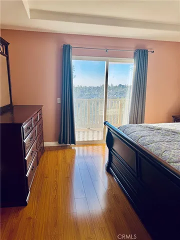 a spacious bedroom with a bed and a large window