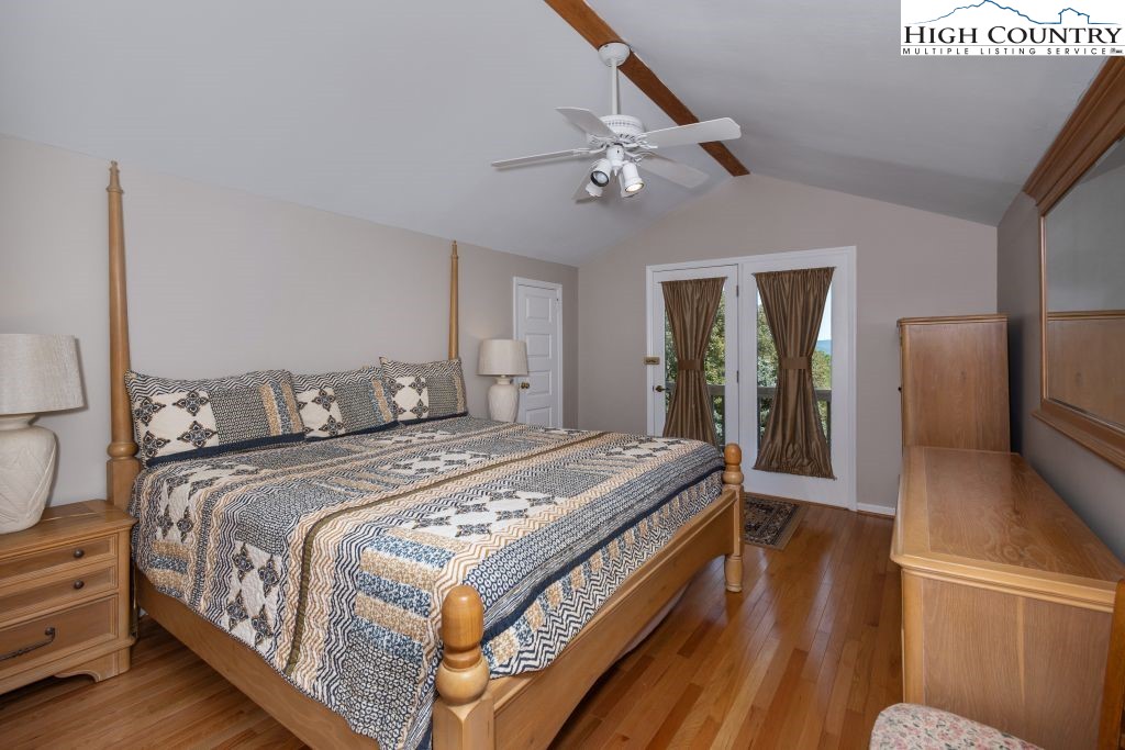 1005 Andy Hicks Road Banner Elk, NC 28604 - Photo 12 of 44 a bedroom with bed and a chandelier