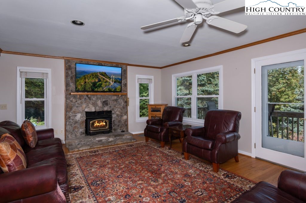 1005 Andy Hicks Road Banner Elk, NC 28604 - Photo 20 of 44 a living room with furniture a large window and a fireplace