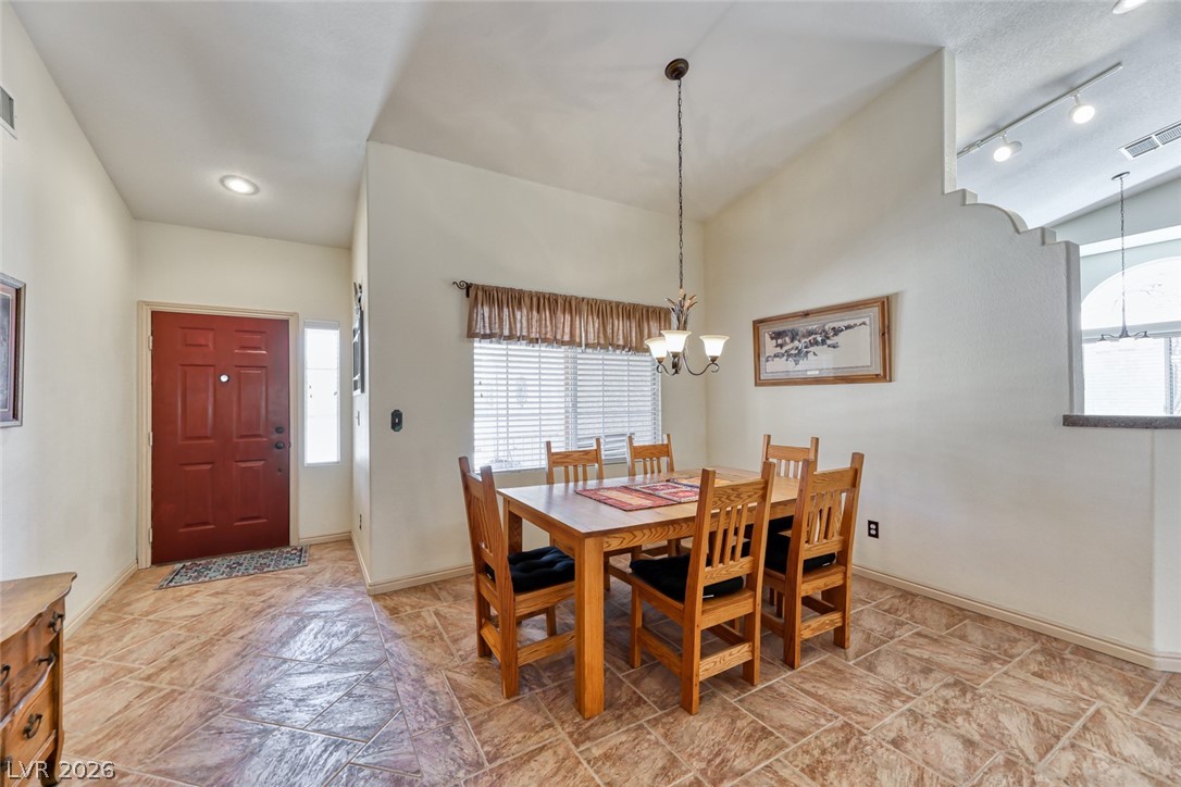 2001 Appaloosa Road Henderson, NV 89002 - Photo 25 of 44 This inviting dining area features warm tile flooring, an elegant chandelier, and abundant natural light.