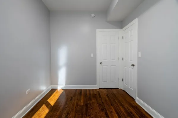 a view of a room with wooden floor and white walls