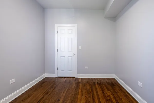 a view of an empty room and wooden floor