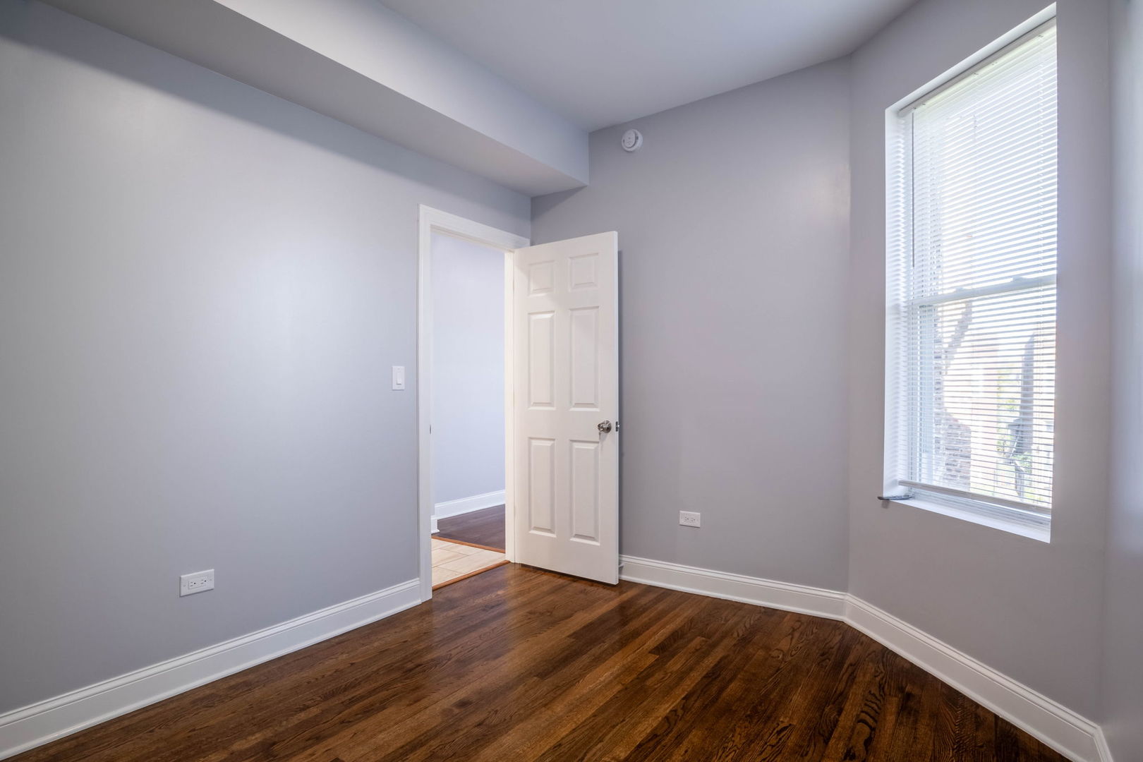 4837 West Monroe Street, Unit 2 Chicago, IL 60644 - Photo 14 of 21 an empty room with wooden floor and windows