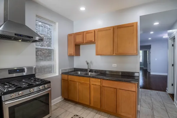 a kitchen with stainless steel appliances granite countertop a stove and a sink