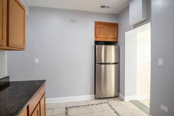a kitchen with a refrigerator and cabinets