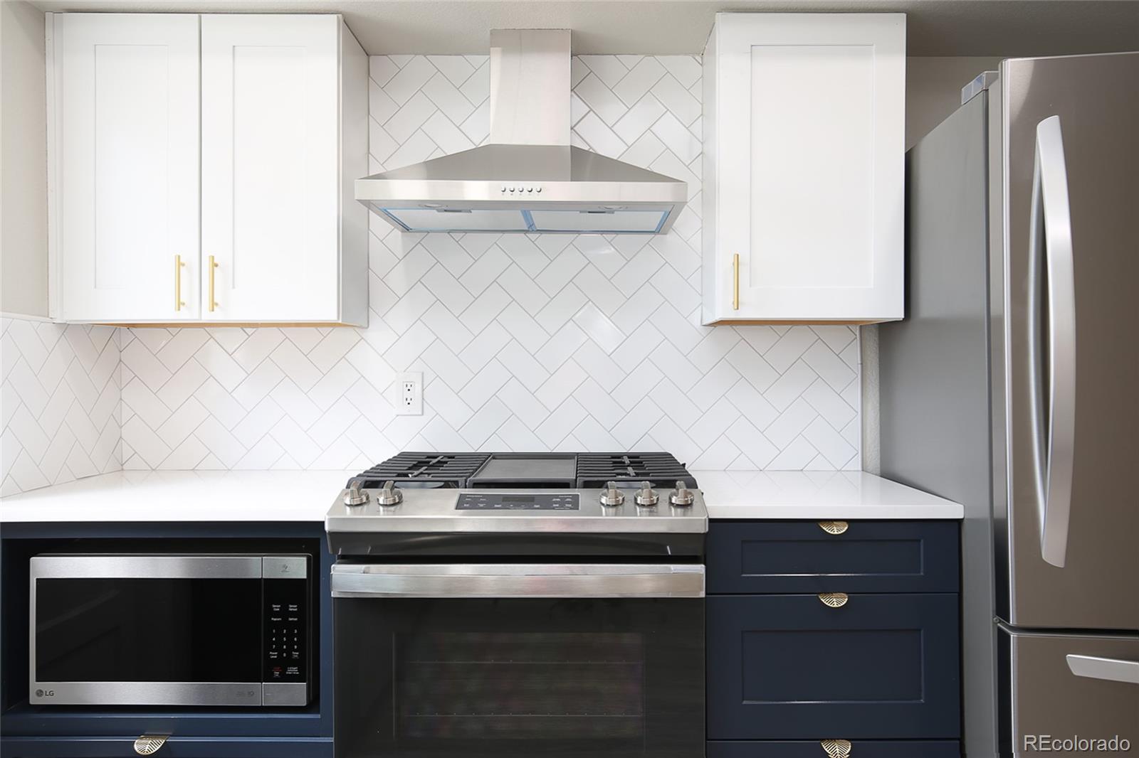4332 North Decatur Street Denver, CO 80211 - Photo 12 of 26 a kitchen with a stove and a microwave