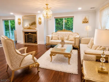 a living room with furniture fireplace and a table
