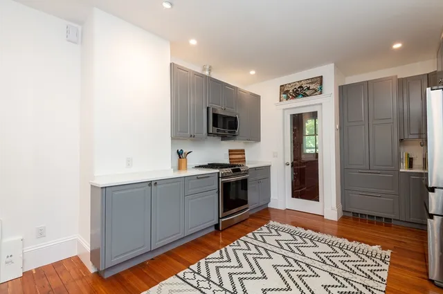 a kitchen with stainless steel appliances granite countertop a stove microwave and sink