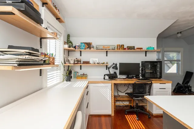 a kitchen with stainless steel appliances a stove top oven a sink dishwasher and a microwave oven with wooden floor