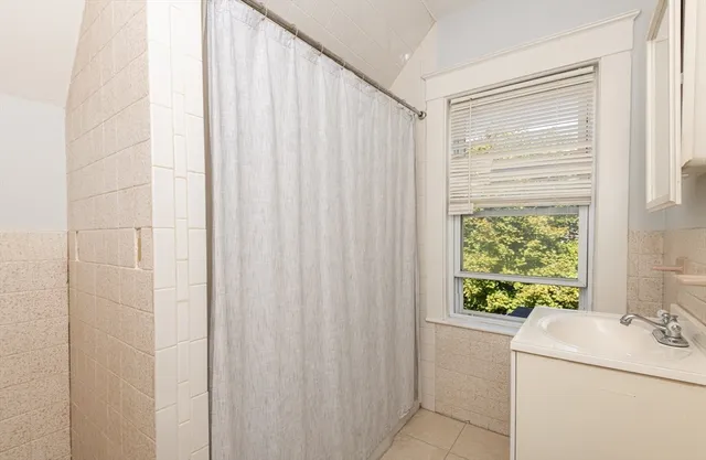 a bathroom with a sink a toilet and a window