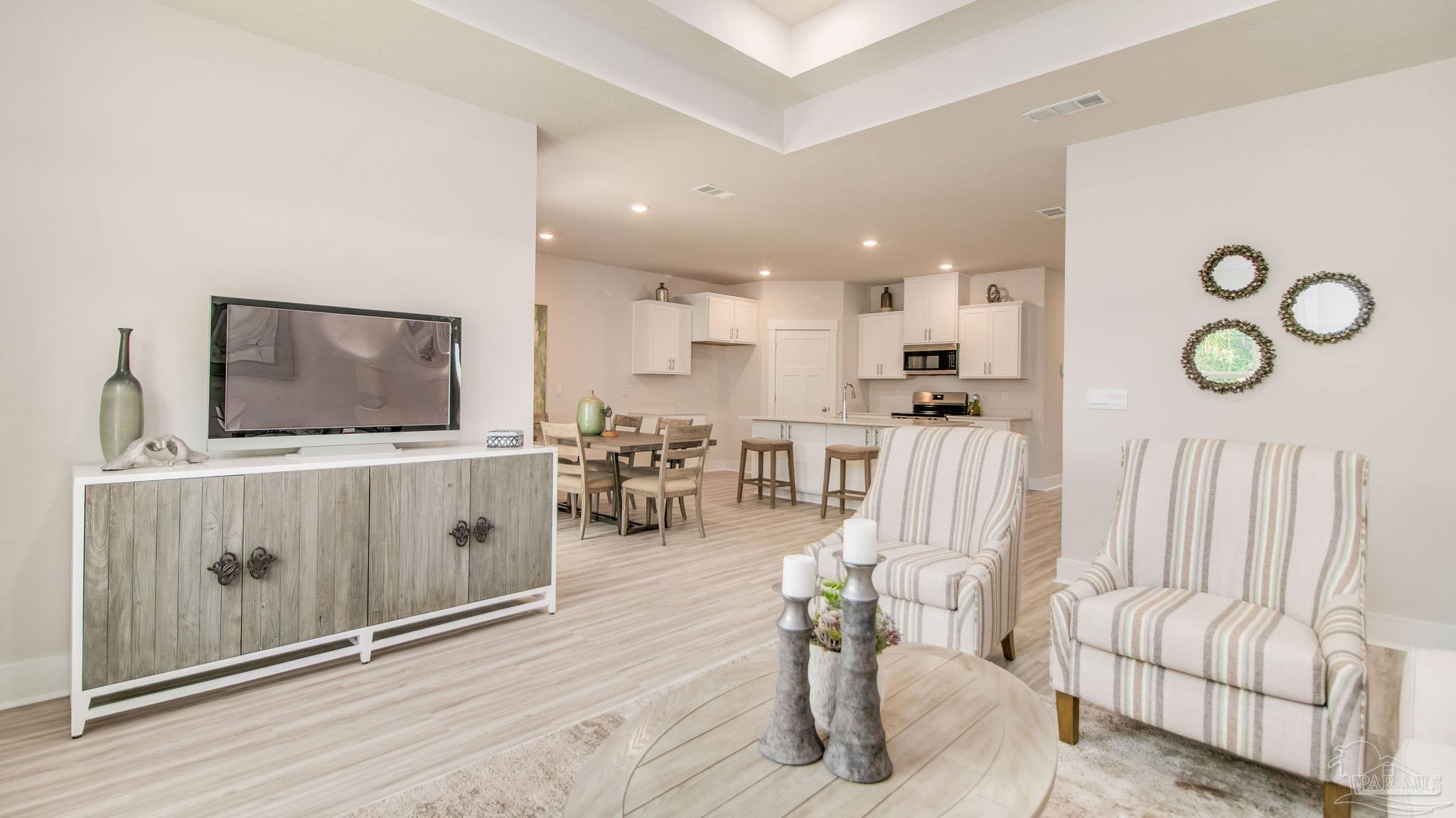 5829 Dove Nest Road Gulf Breeze, FL 32563 - Photo 11 of 31 a living room with furniture and a flat screen tv