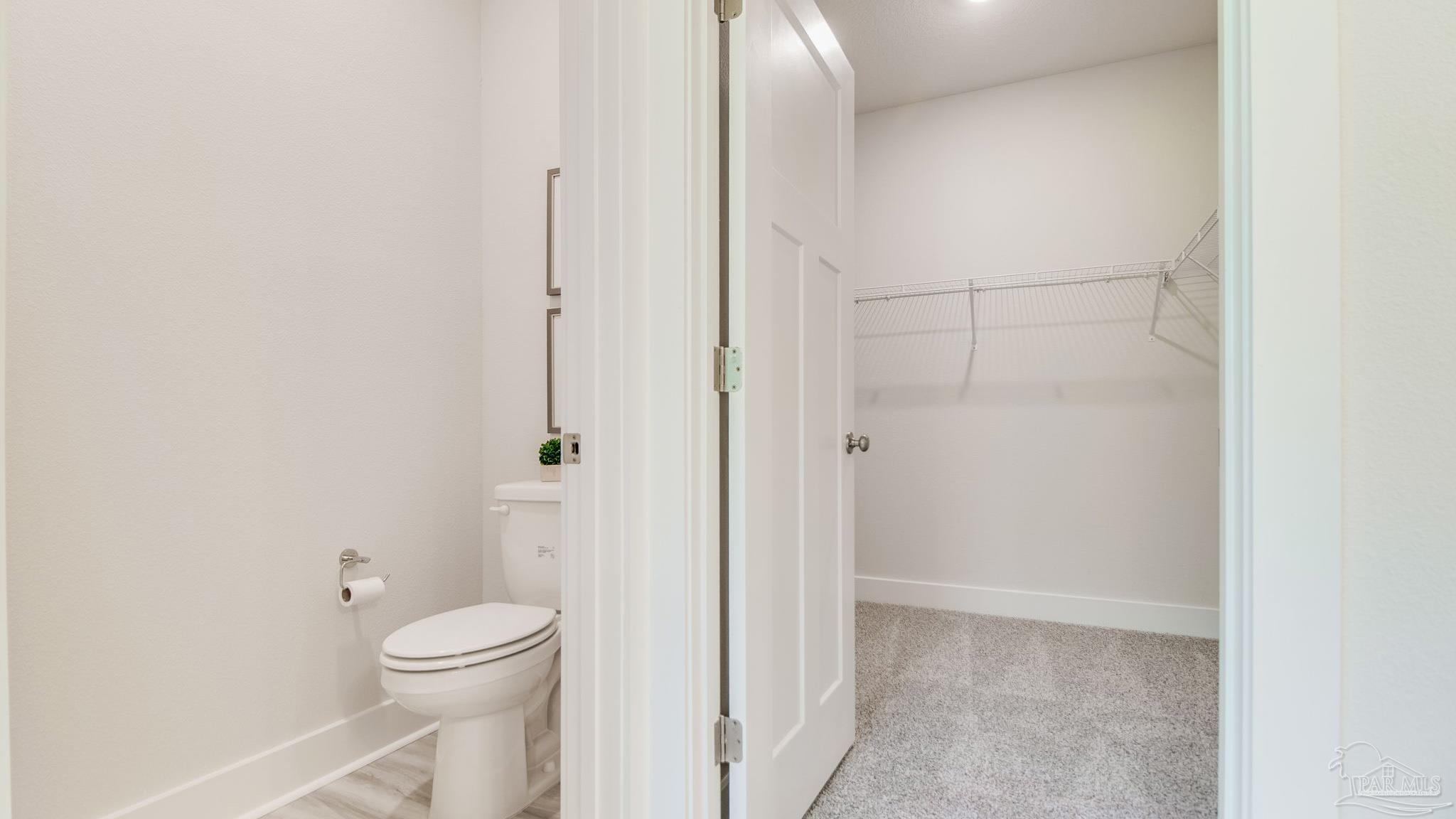 5829 Dove Nest Road Gulf Breeze, FL 32563 - Photo 22 of 31 a bathroom with a toilet and a shower