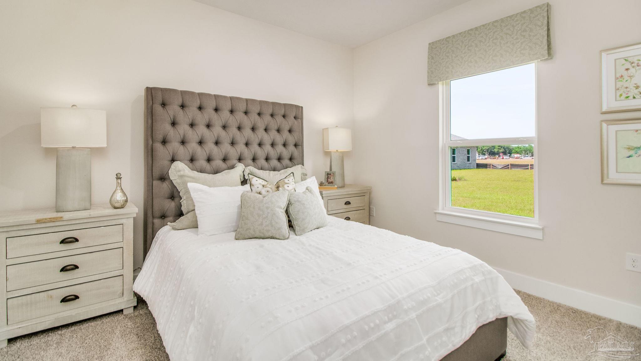 5829 Dove Nest Road Gulf Breeze, FL 32563 - Photo 26 of 31 a bedroom with a bed and a window