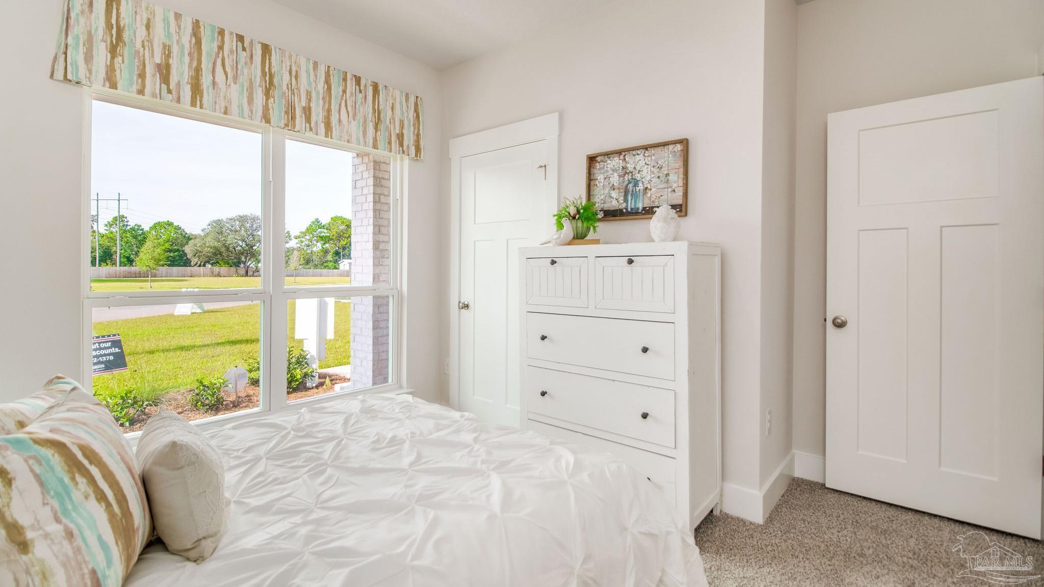 5829 Dove Nest Road Gulf Breeze, FL 32563 - Photo 29 of 31 a bedroom with a bed and a window