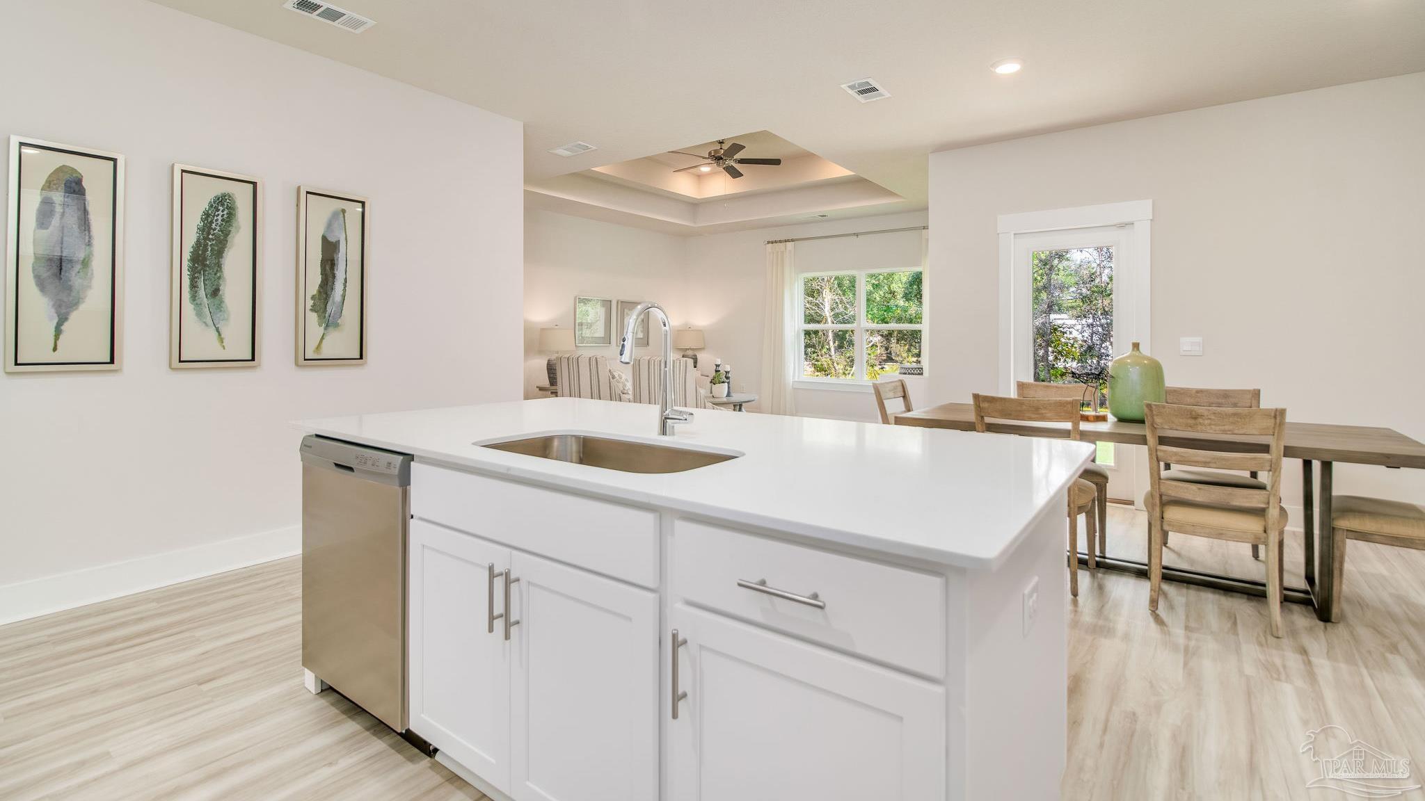 5829 Dove Nest Road Gulf Breeze, FL 32563 - Photo 5 of 31 a kitchen with a sink cabinets and wooden floor