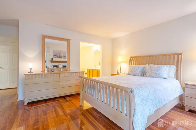 a bathroom with a granite countertop sink a large mirror and bathtub